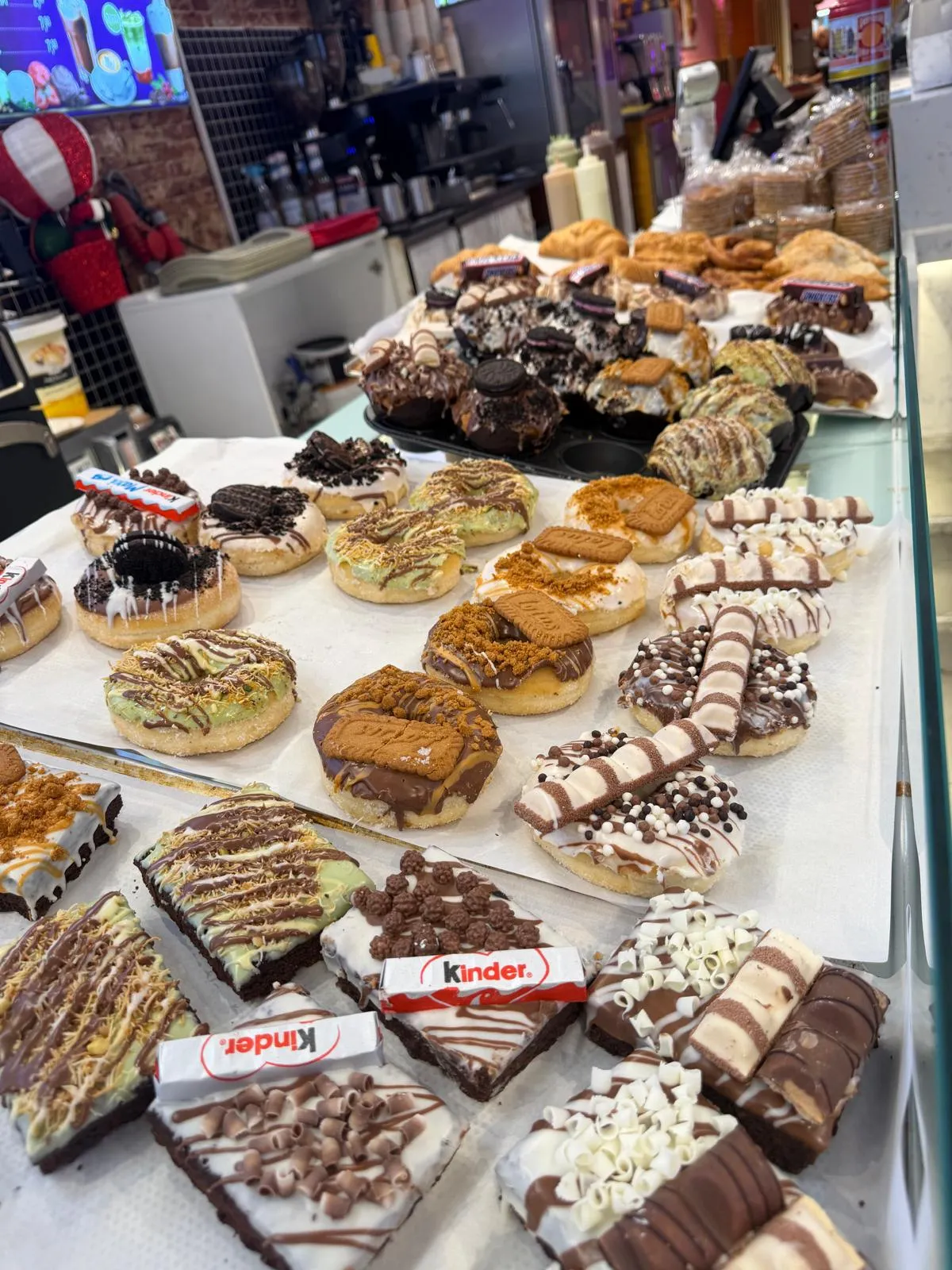 A tray of filled pastries, brownies and doughnuts on the counter