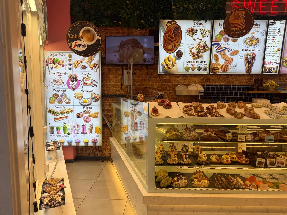 The inside of Sweet Bakery seen from the door, with the counter along the right
